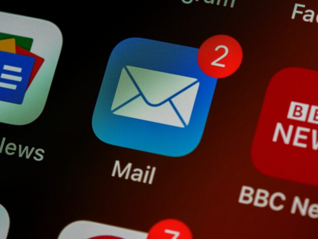 The Home Screen of an iPhone with the email icon showing 2 unread messages.
