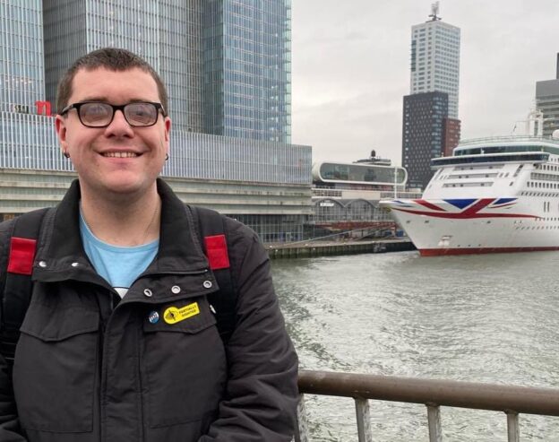 Chris Jeffery, wearing a partially sighted badge, stood in front of the P&O Aurora cruise ship as its docked in Rotterdam.